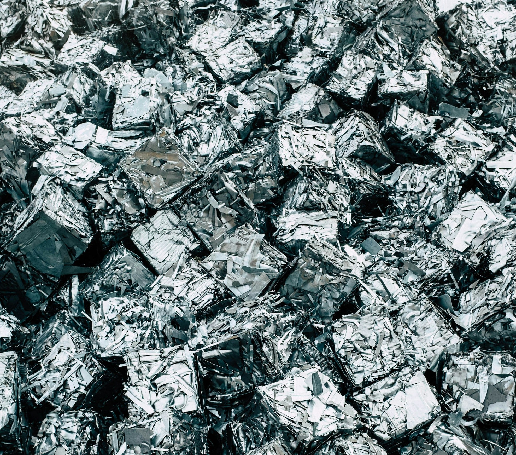 a pile of silver foil sitting on top of a pile of silver foil